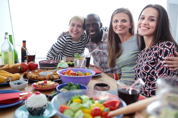 Smiling people sharing a meal at a table